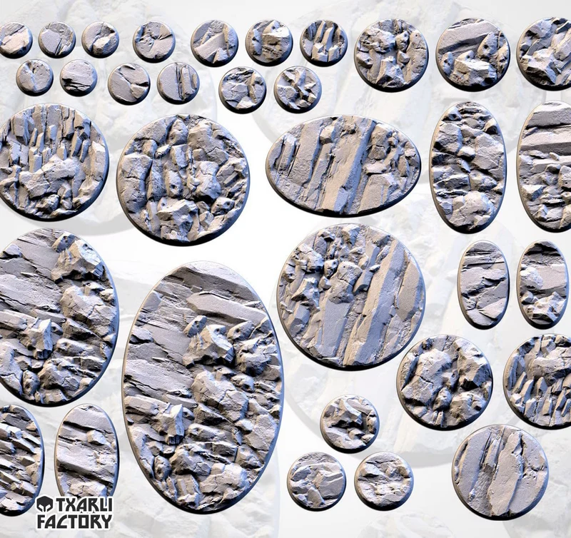 Thirteen round and oval tabletop bases with layered, fractured rocky surfaces