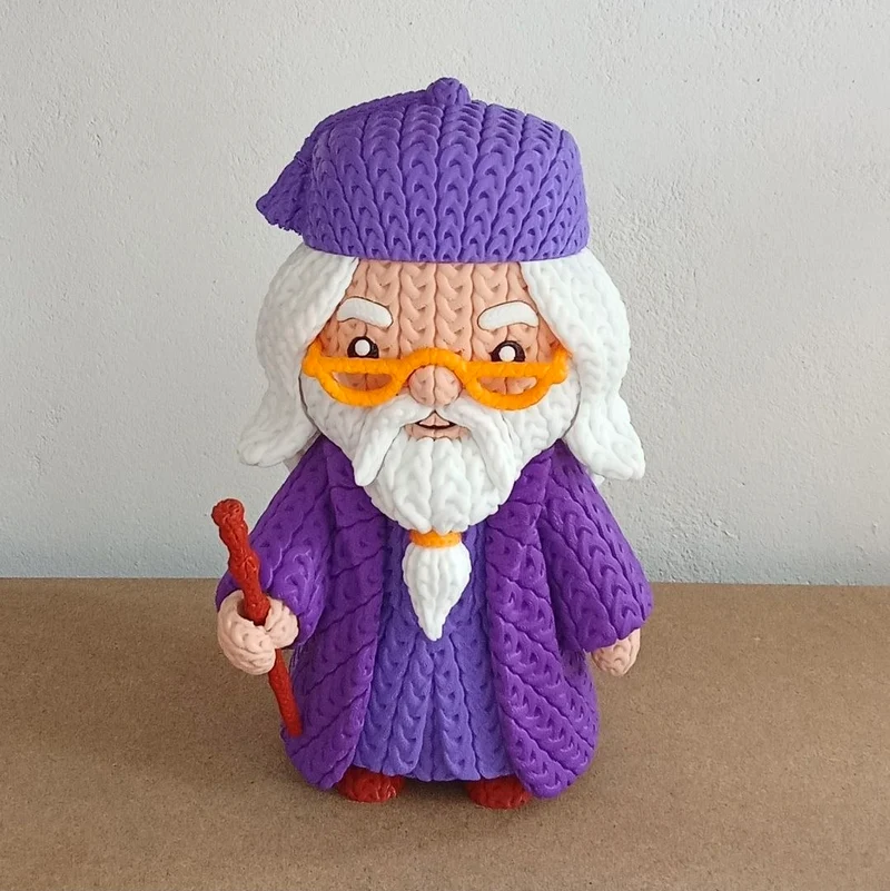 Stylized Alvo Dumbledore figurine with purple robes, white beard, orange glasses, and a wand