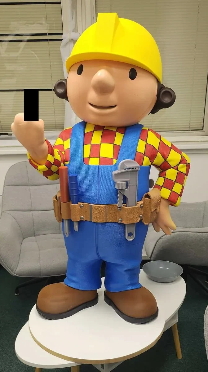 Bob the Builder character figure wearing a yellow hard hat and blue overalls