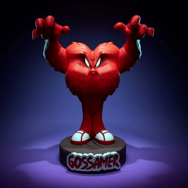 Gossamer from Looney Tunes standing on a labeled display pedestal