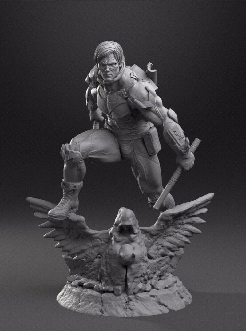Nightwing statue holding a staff above a winged bird base