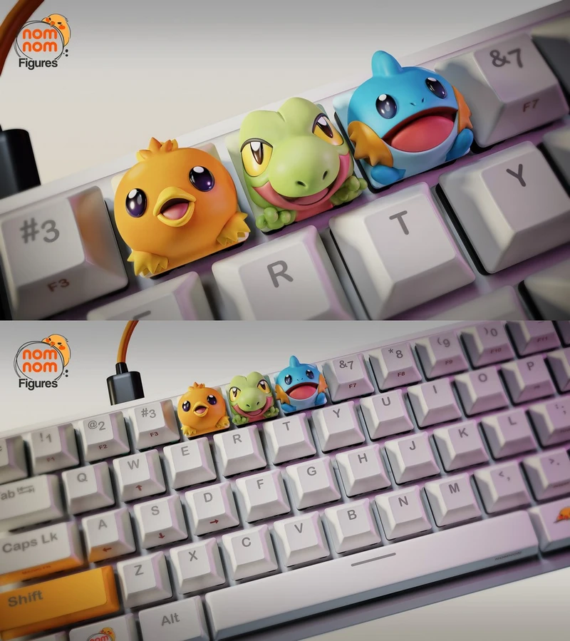 Torchic, Treecko, and Mudkip Pokémon figures arranged on a computer keyboard