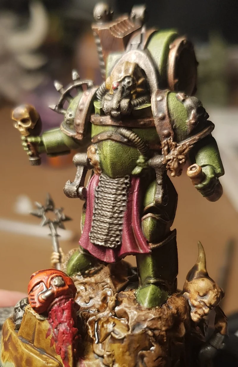Unidentified green sci-fi armored warrior miniature with skull staff and textured scenic base