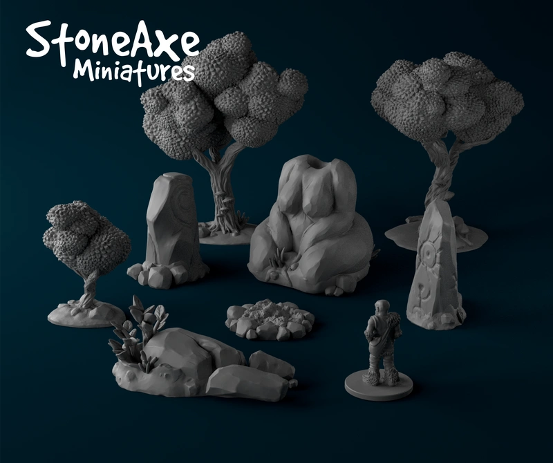 Fantasy tabletop terrain set with textured trees, rocks, stone figure, and miniature