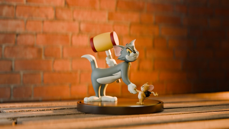 Tom raising a mallet over Jerry in a Tom and Jerry cartoon statue
