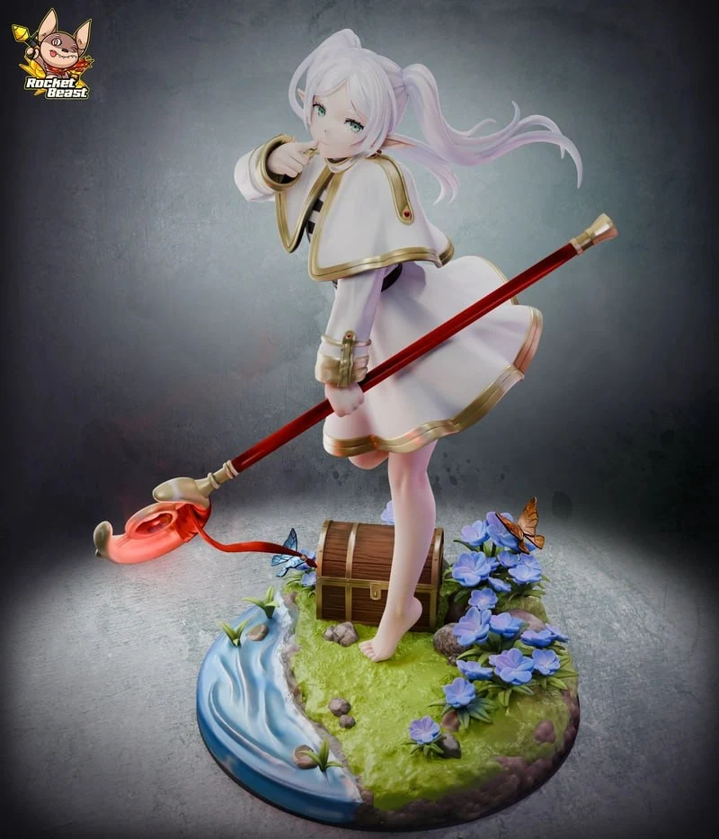 Frieren anime character statue with a red staff on a floral fantasy base