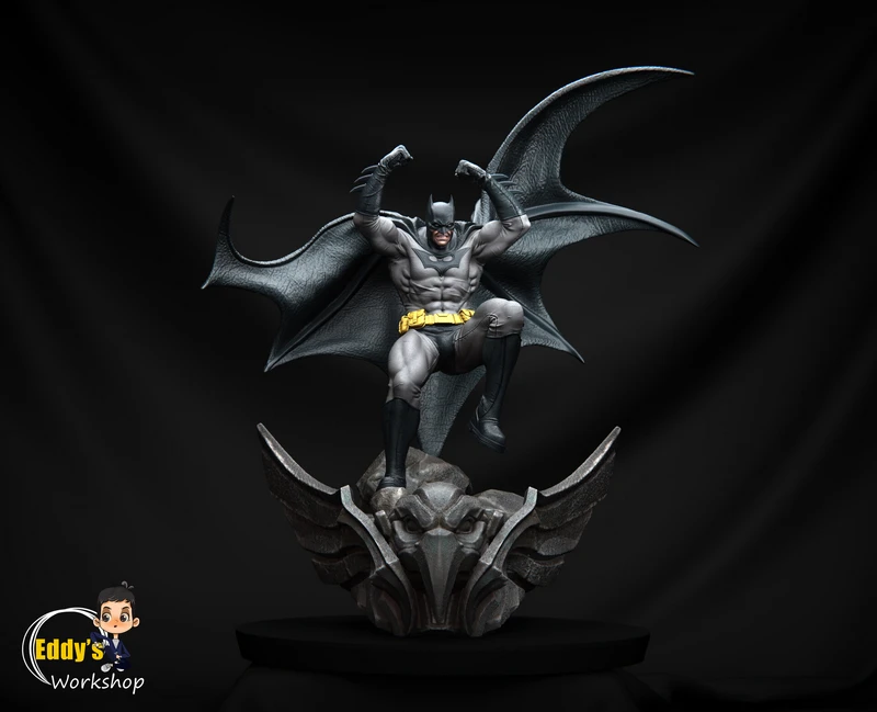 Batman statue crouching above a winged gargoyle base with cape spread wide