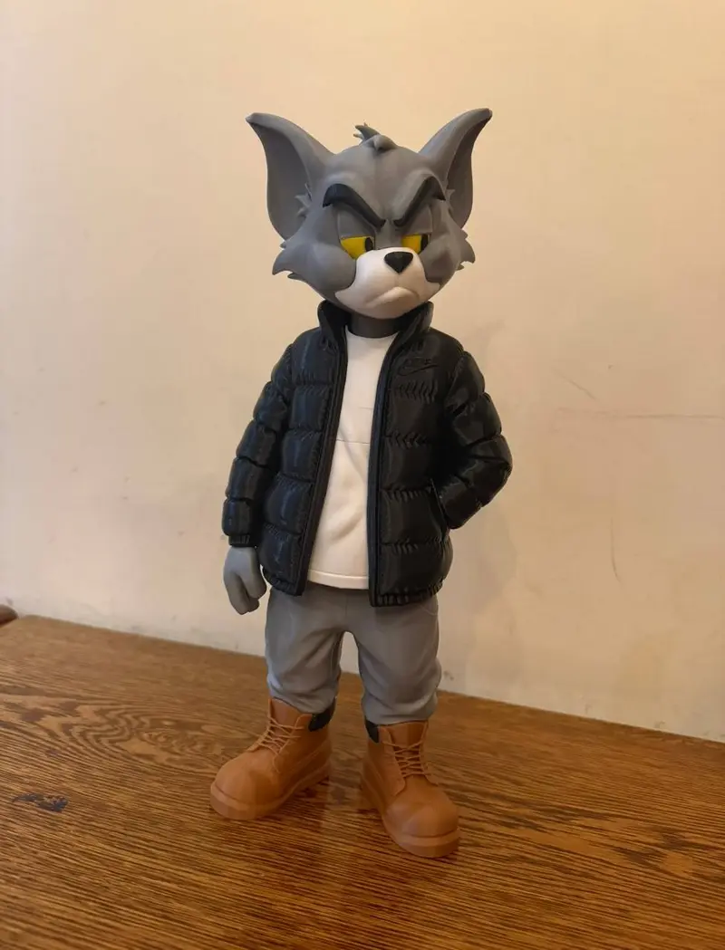 Tom from Tom and Jerry wearing a puffer jacket, shorts, and boots