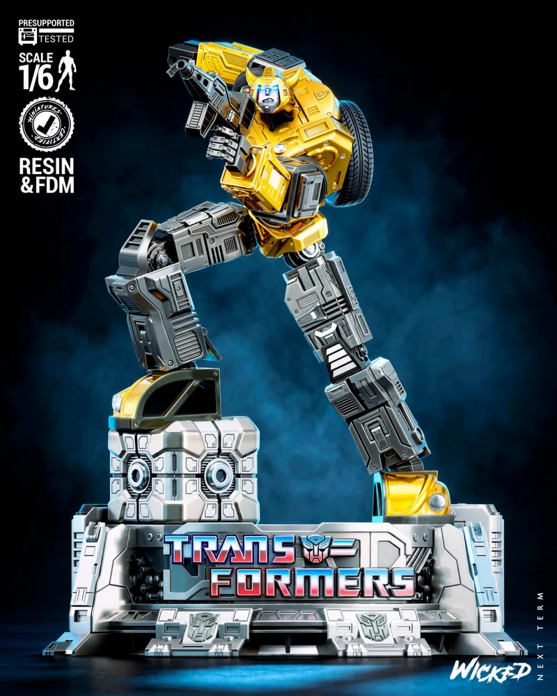 Yellow Bumblebee Transformers robot sculpture with blaster on a branded display base