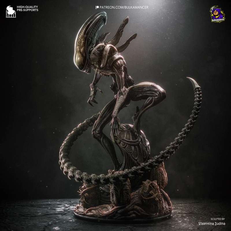 Xenomorph Alien statue with domed head, curled segmented tail, and organic display base