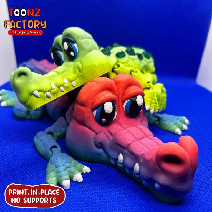 Colorful articulated crocodile 3D printed figurine with large eyes and segmented limbs